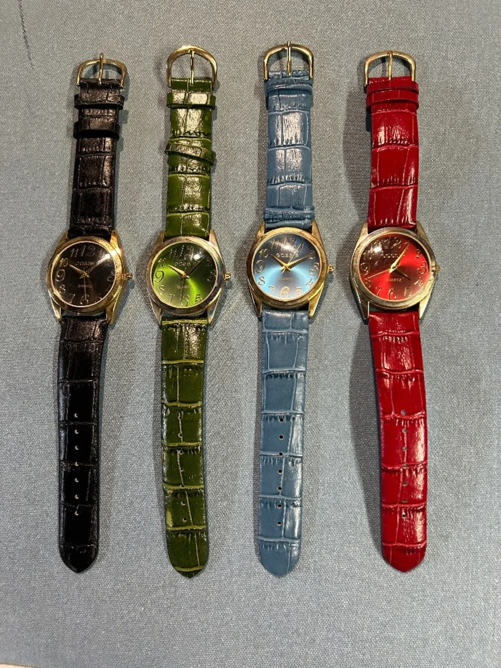 Four Gossip GSP471A vintage women's quartz wristwatches with a gold tone case.